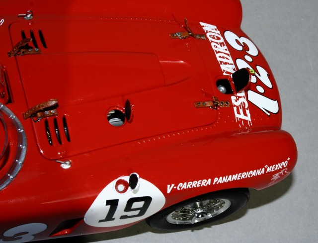 Gondolom a versenyszerelők sem szerethették ezt a szíjas megoldást. Ezért a fontosabb folyadékokat a kis fedelek alatti nyíláson lehetett utántölteni.